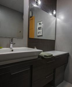 a bathroom with a white sink and a mirror at Alojamiento Santo Reino de Jaén in Jaén