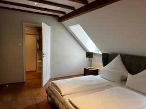 a bedroom with a large bed and a window at Hofgut Holzmuhle in Germersheim