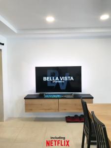a flat screen tv sitting on top of a wooden table at Bella Vista apartment 2 in Izola