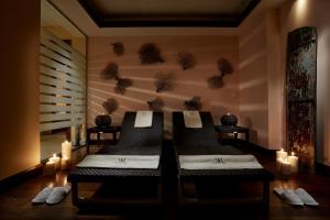 a massage room with two massage tables and candles at Rodos Park in Rhodes Town