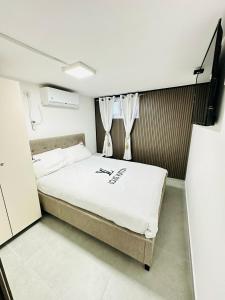 Un dormitorio con una cama grande en una habitación. en אופק במדבר - 2 חדרי אירוח מקסימים ונעימים קרוב לטיילת ולים, en Eilat