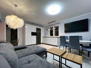 a living room with a couch and a table at PaVoni Apartments Veranda Blu Mare in Łeba