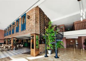 a lobby of a building with a brick wall at Biography Design Tbilisi in Tbilisi City