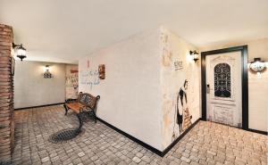 a bench sitting in a room with a wall with graffiti at Biography Design Tbilisi in Tbilisi City