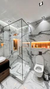 a bathroom with a glass shower and a toilet at Apartment for tourists in Samarkand