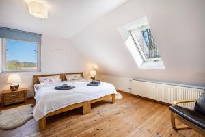 a bedroom with a bed and a couch and a window at Voßberg Fewo 2 in Grömitz