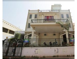 a building with a fence in front of it at Hotel Kamesh Hut, Varanasi in Varanasi
