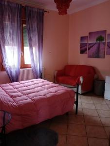 a bedroom with a bed and a red couch at Home Sweet Home in Bologna