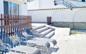 a group of blue chairs sitting on a patio at CAP RAS 40 A in Empuriabrava