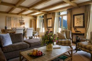 a living room with a couch and a table at Gstaad Palace in Gstaad