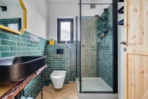 a bathroom with a sink and a glass shower at Gnievo 11 in Międzylesie