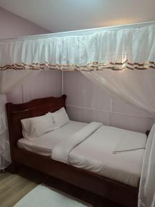 a pair of beds in a room with a canopy at The white rock 2023 in Eldoret
