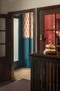 a room with aoyer with a door and a table at St. David's Hotels Paddington in London