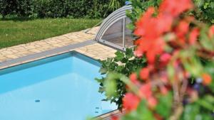 a swimming pool in a garden with a mirror at Pension Kreuzberghof in Großklein