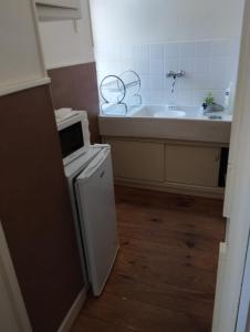 a bathroom with a sink and a tub and a microwave at MAISON ALBA LA SOURCE in Mazamet +18 photos