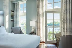 a bedroom with a bed and a large window at The Cotton Sail Hotel Savannah - Tapestry Collection by Hilton in Savannah +44 photos