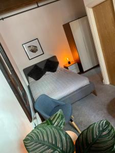 a bedroom with a bed and a chair at WE-stay in Manchester