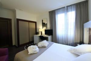 Postel nebo postele na pokoji v ubytování Gran Hotel España