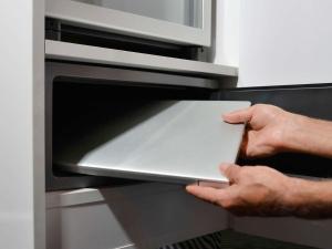 a person is putting a tablet in an oven at Fora Hotel Hannover by Mercure in Hannover