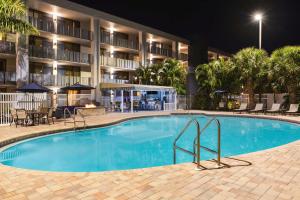 a swimming pool in front of a hotel at night at Spark by Hilton Sarasota Siesta Key Gateway in Sarasota