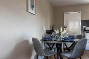 a dining room with a table with chairs at Perth House in Clydebank
