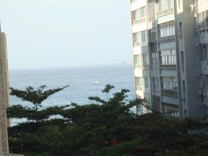 una vista del océano desde dos edificios en Apart Marcelo - Copacabana, en Río de Janeiro