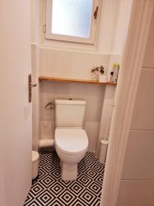 a small bathroom with a toilet and a window at in paris in Villejuif