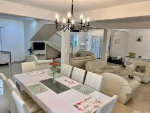 a dining room and living room with a table and chairs at Salty Château in Cap Malheureux