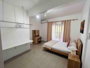 a bedroom with a bed and a desk in it at Salty Château in Cap Malheureux +47 photos