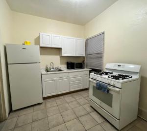 a kitchen with a white refrigerator and a stove at GUEST HOUSE NEAR DOWTOWN BOSTON in Boston