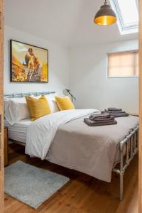 ein Schlafzimmer mit einem großen Bett mit gelben Kissen in der Unterkunft Luxury City Centre Accommodation Sleeping 2 in Norwich