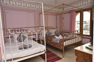 a bedroom with two bunk beds and a desk at Hotel Rime Vista in Jaipur