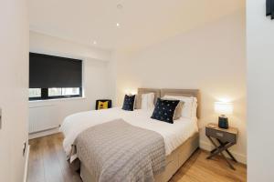 a bedroom with a bed and a large window at Solihull Modern Living - 1 Bed Apartment in Solihull