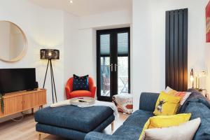a living room with a blue couch and a chair at Solihull Modern Living - 1 Bed Apartment in Solihull
