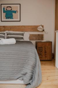 a bedroom with a bed with a wooden headboard at Spacious Norwich Lanes Apartment with Roof Terrace in Norwich