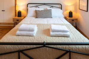 1 dormitorio con 1 cama con 2 almohadas en Stylish Quayside Apartment with River View en Norwich