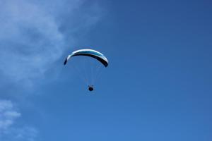 a paraglider flying in the blue sky at Haus Johanna in Radstadt