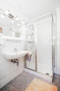 a bathroom with a sink and a shower at Haus Hubertus in Fusch an der Glocknerstraße