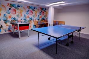 a ping pong table in a room with a ping pong ball at Ferienhotel Iris in Auffach