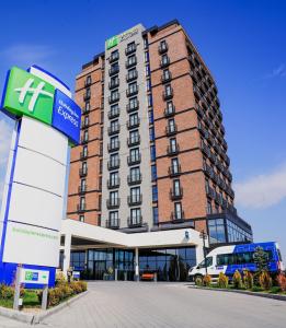 a building with a bus parked in front of it at Holiday Inn Express - Ankara - Airport, an IHG Hotel in Ankara