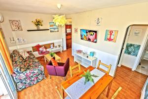 a living room with a couch and a table at Plaza de Toros 3-Bedroom Apartment with Balcony in El Puerto de Santa María +28 photos