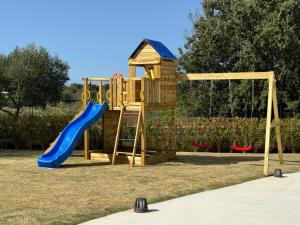 a wooden playground with a slide and a playset at Kyamon Estate Luxury Villa in Galangádhos