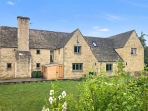 a large stone house with a large yard at Tree Tops House in Cheltenham