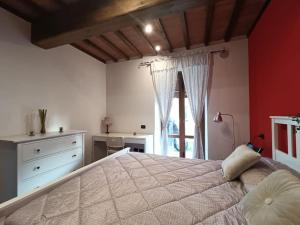 a bedroom with a large bed and a window at The Twin House in Lucca