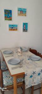 a table with plates on top of it with paintings at Casa Mugnai in Piombino