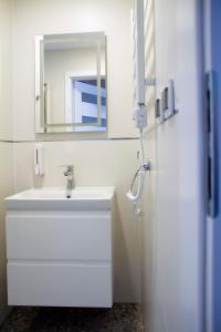 a bathroom with a white sink and a mirror at apartamenty Szwajcarka in Kudowa-Zdrój