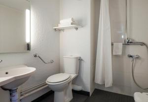 a white bathroom with a toilet and a sink at B&B HOTEL Marseille Parc Chanot in Marseille