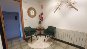 a room with two chairs and a table and a fire hydrant at Pensión QuintAna in Prellezo