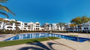 a large swimming pool in front of some buildings at Casa Esturion T-A Murcia Holiday Rentals Property in Roldán