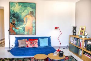 ビアリッツにあるOSSUNA KEYWEEK Very nice apartment close the main beach in Biarritzのリビングルーム(青いソファ、絵画付)